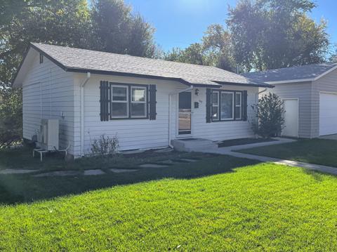 Front exterior of 943 Raymond Place with large front lawn