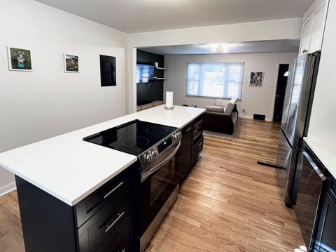 Kitchen with quartz island and slide-in range