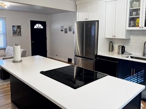 Quartz island and white shaker cabinets