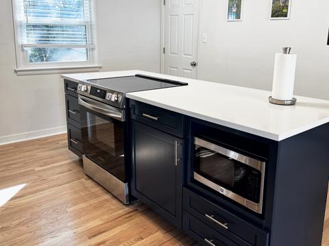 Kitchen with built-in microwave and range
