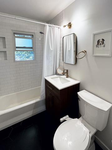 Remodeled bathroom with subway-tile tub surround